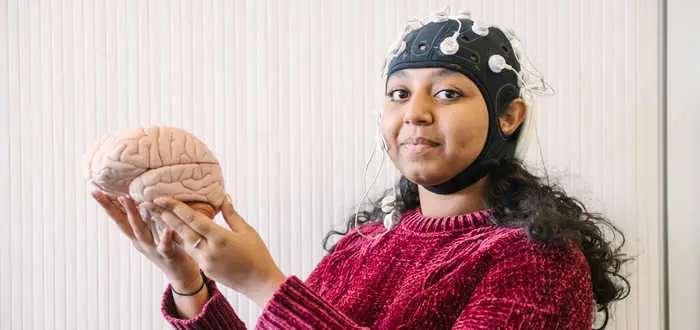 female student holding brain mode