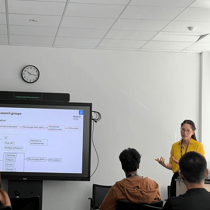 A presentation taking place in a classroom, with speaker engaging with the audience