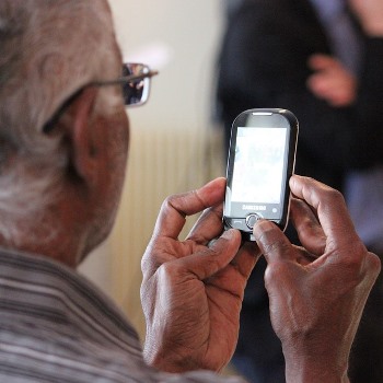 old man looking at phone