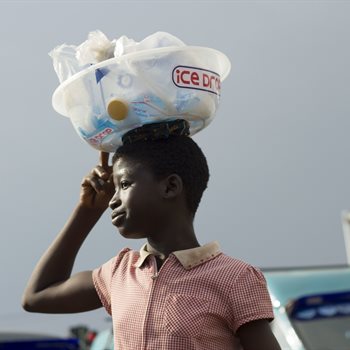 girl carrying bags of water