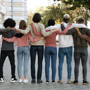 A back view of people hugging on the street