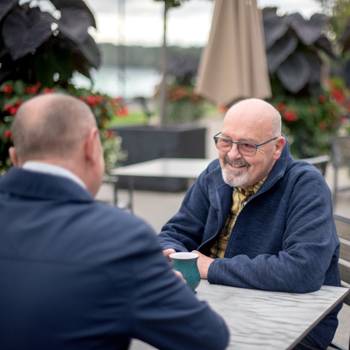 Older gay couple having tea