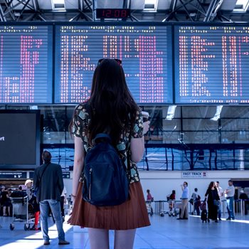 woman waiting for her flight at an airport
