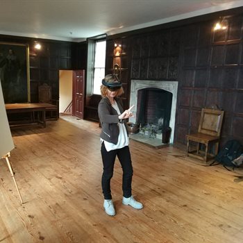 arwoman wearing ar glasses in a heritage home