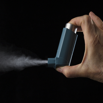 man spraying asthma inhaler
