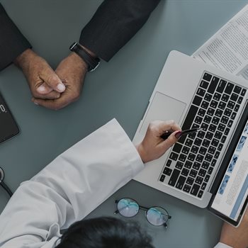 doctor showing a patient something on a tablet