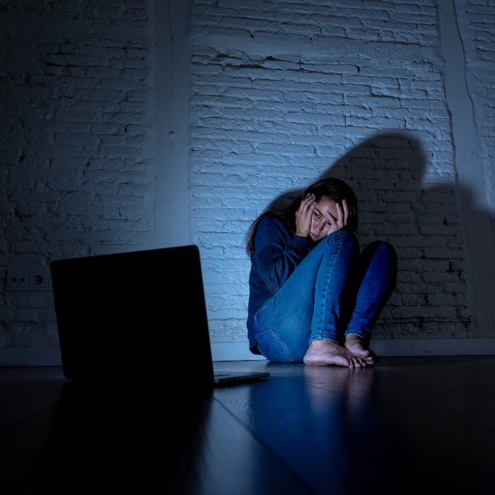 woman shocked at the content on the laptop