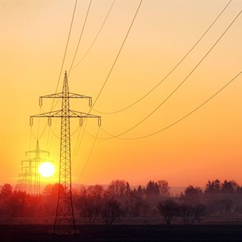 electrical pole against sunset