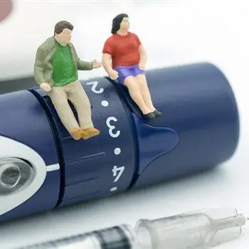 male and female toy figures on a diabetes device