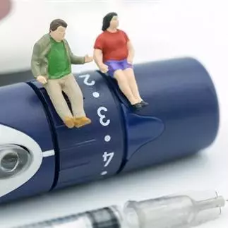 male and female toy figures on a diabetes device