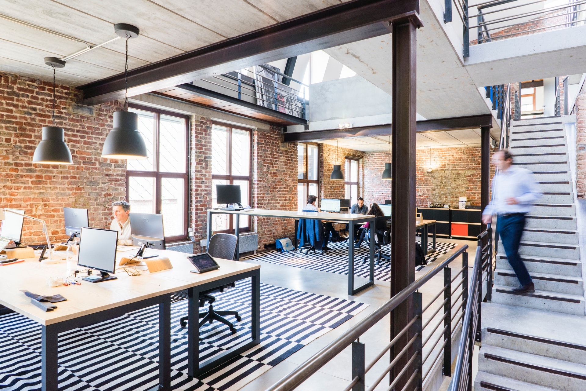 man walking down steps in office