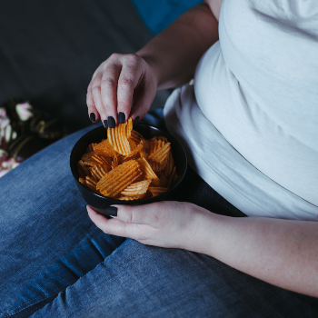 woman sitting on sofa and eating