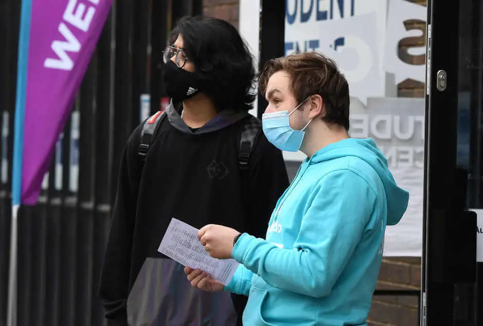 students in facemask in front of the Brunel Student Centre