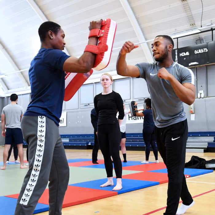 Two sports students practicing MMA