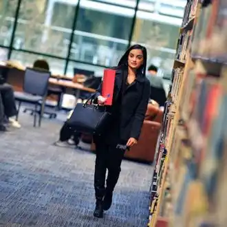Student walking in the library