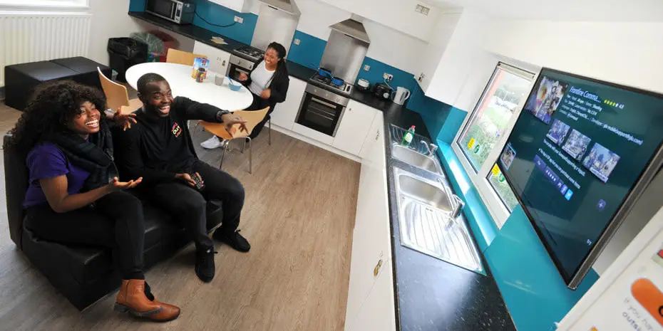 Brunel students watching TV in accommodation kitchen