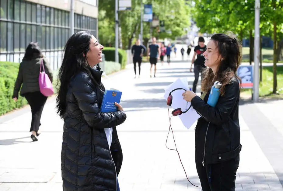 Two female students talking to each other