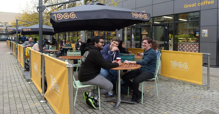 students chatting in Brunel University 1966 Coffee shop outdoor terrace