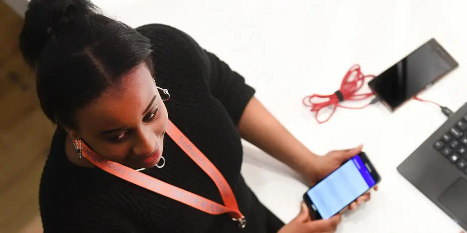 student talking with mobile in her hand