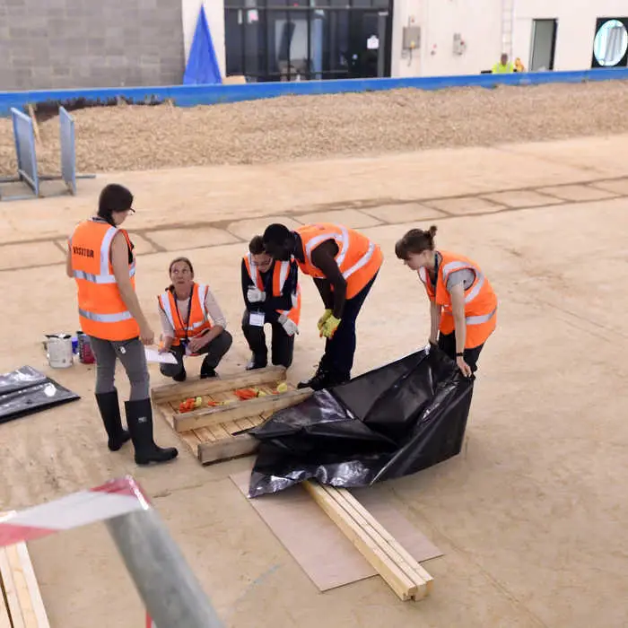 Students inspecting flood defence