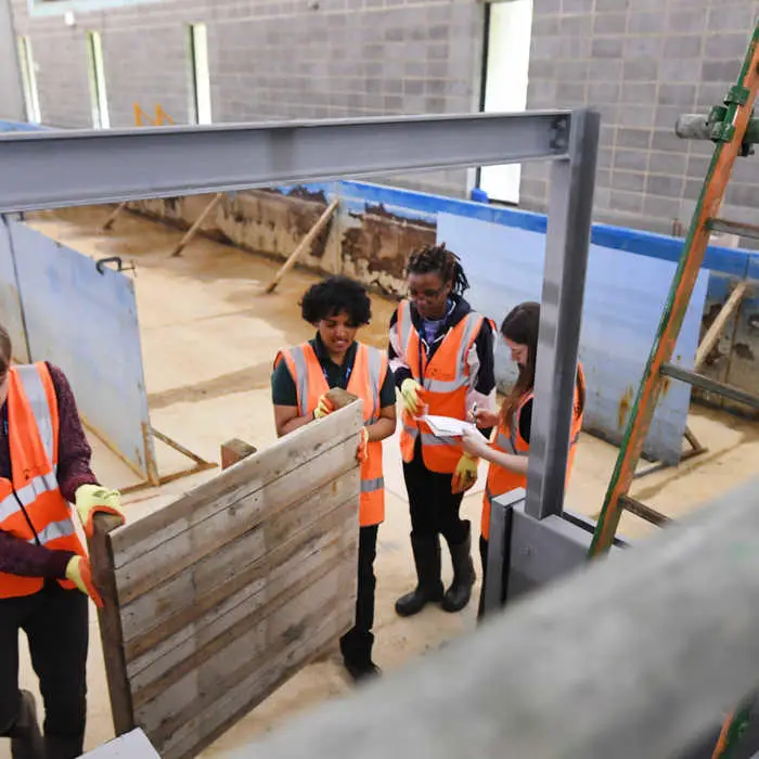 Students inspecting flood defence