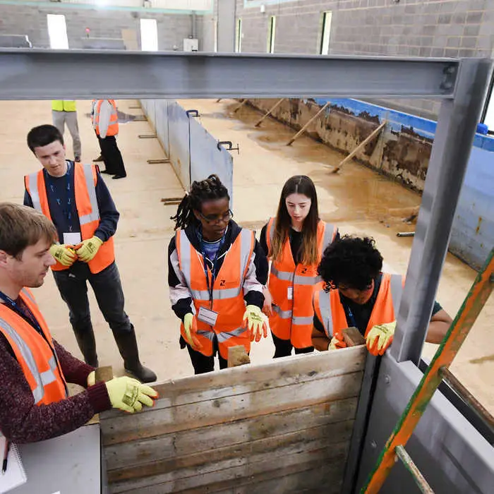 Students inspecting flood defence