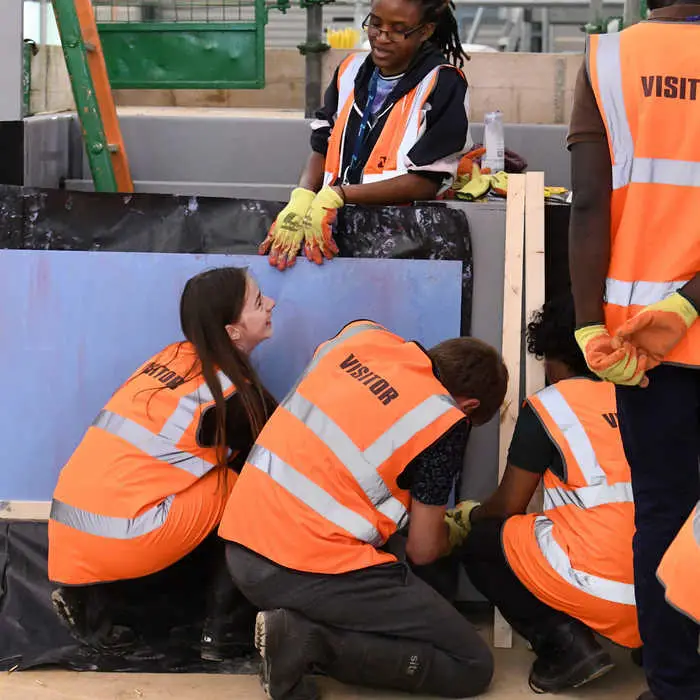 Students inspecting flood defence