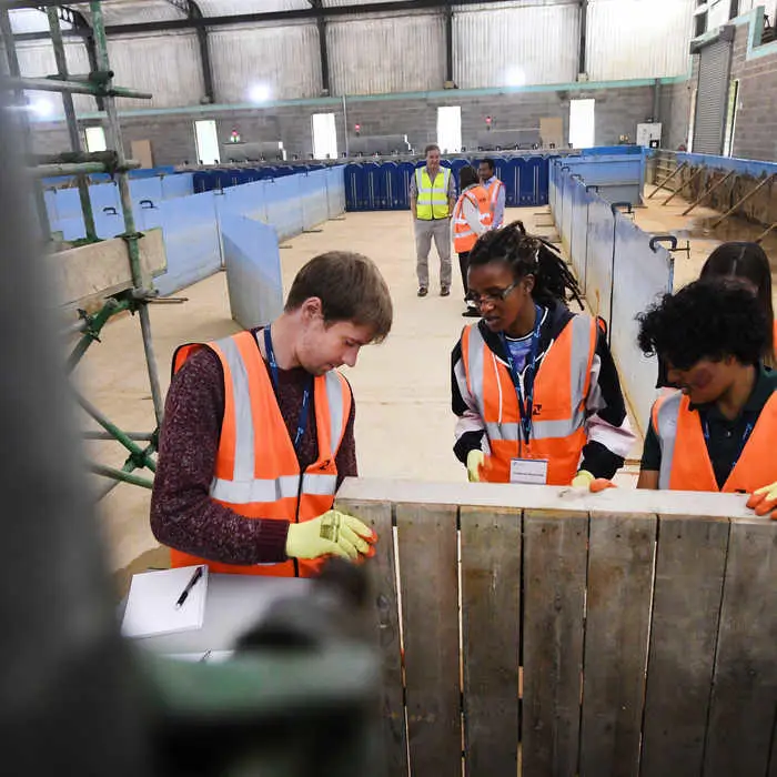Students inspecting flood defence