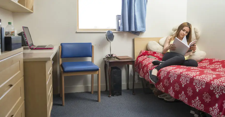 Student reading in her halls room