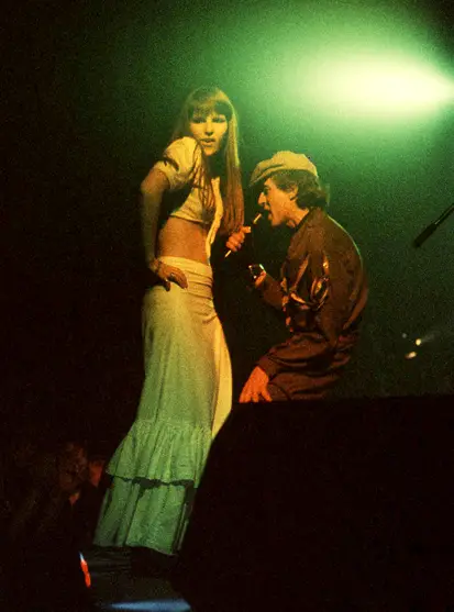 Hawkwind performers on stage with a spotlight behind them