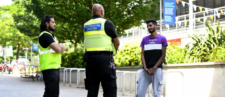 Security on campus chatting to a student