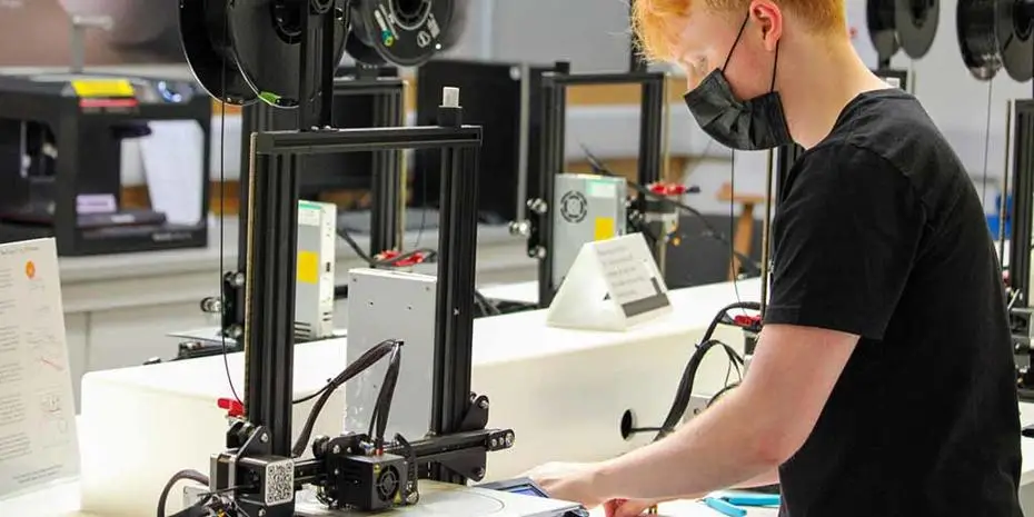 student working in the Brunel Design workshop with a 3D printer