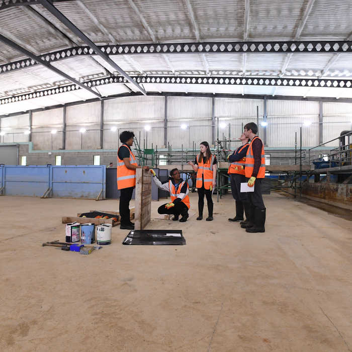 Students inspecting flood defence
