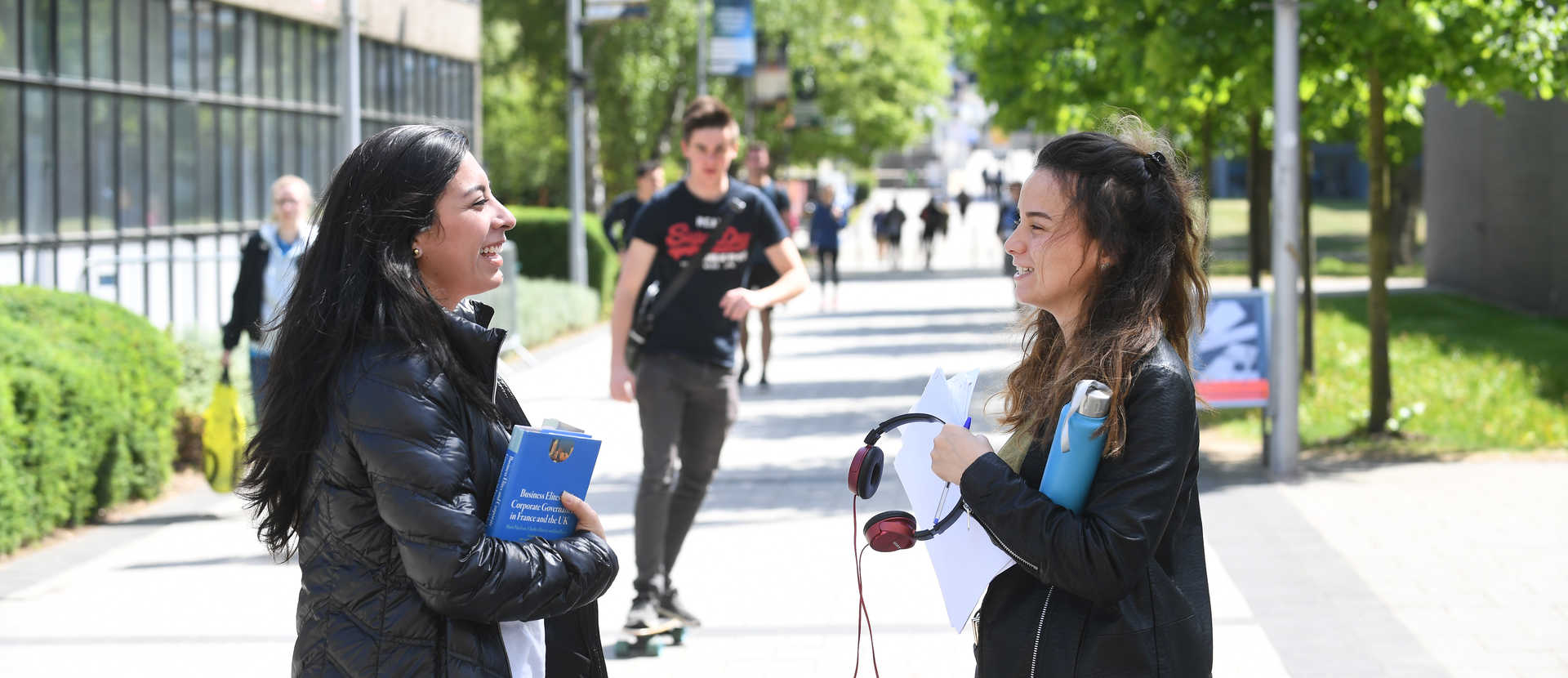 Students on the concourse talking about their university essentials.
