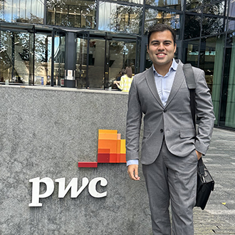 Armaan walking outside the entrance of PwC building
