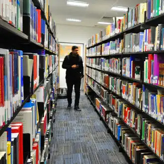 student walking in Brunel Library