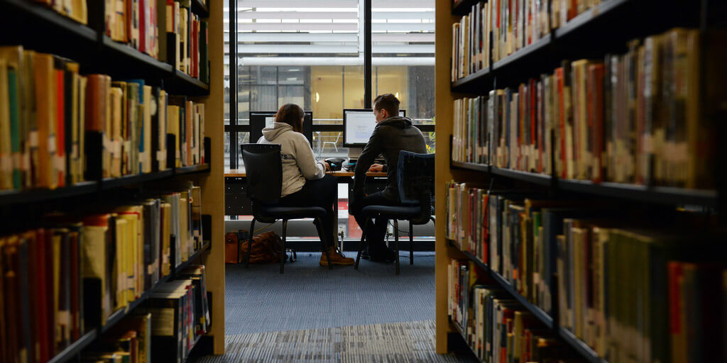 two students studying by a PC in Brunel Library