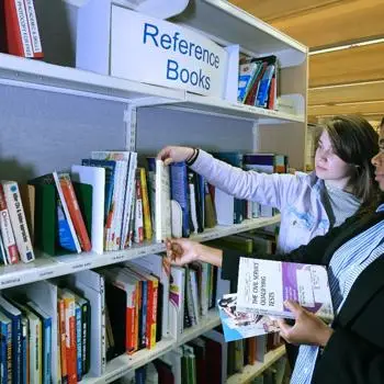 image of two students in library