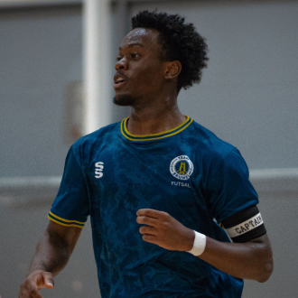 Ayo Otoling wearing blue jersey and playing futsal