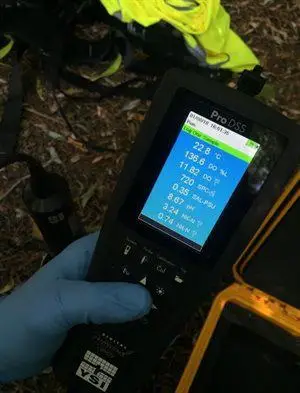 Student using a multimeter to measure pH levels and temperature