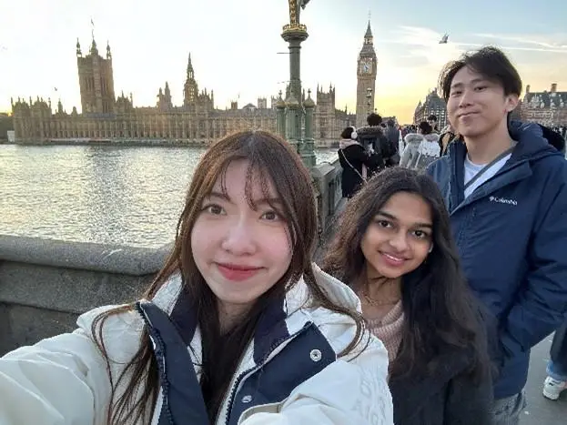 Students smiling in London with River Thames and Big Ben in the background