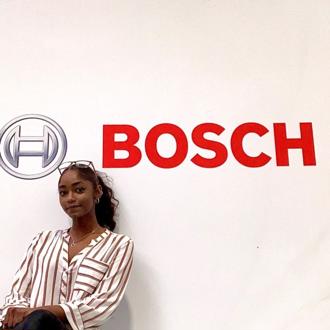 Tasneem sitting below Bosch Logo