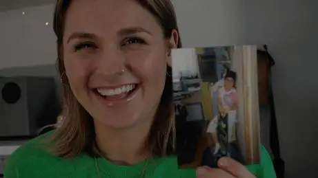 Woman holding a photo of a child