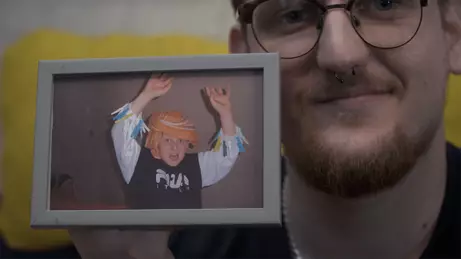Man holding photo of child