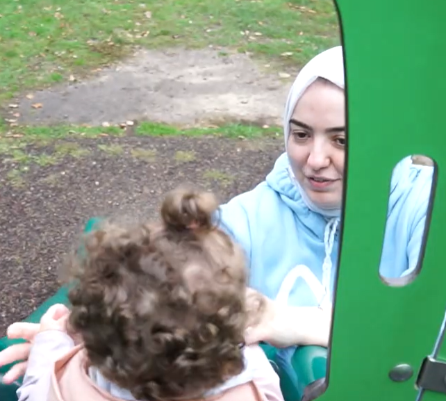 Roua Jumran lifting a child Image
