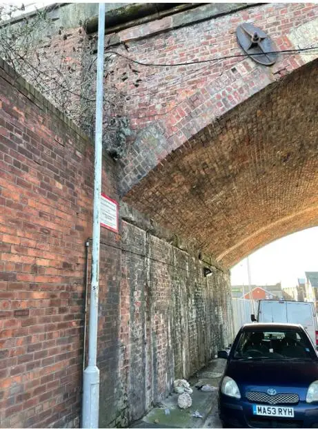Inside of the Great Howard Viaduct with a car parked underneath