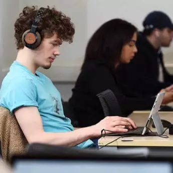 male student working on a laptop