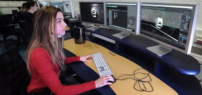 Female student designing digital graphics on a computer