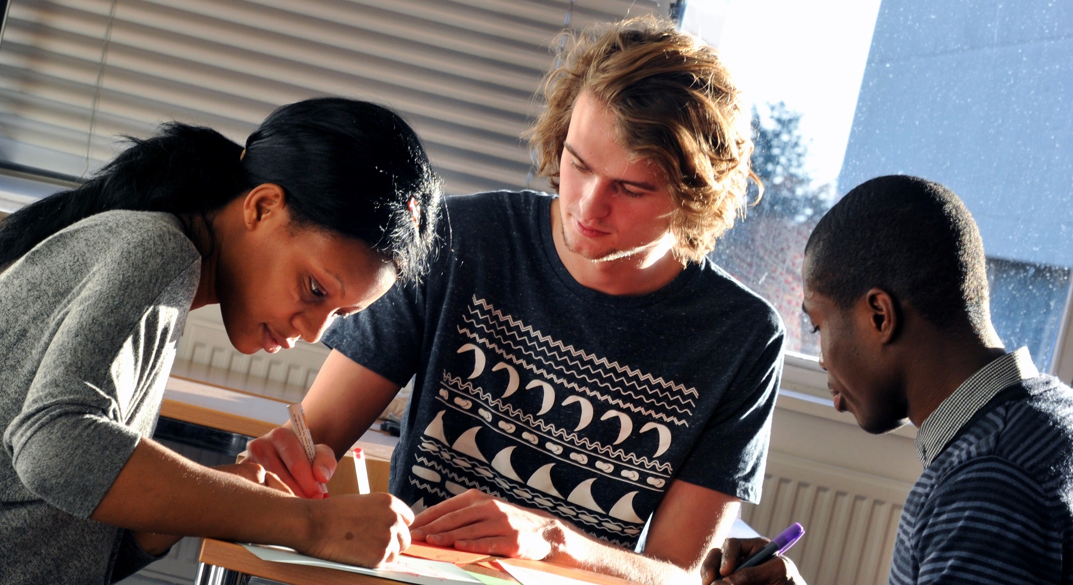 image of three students working