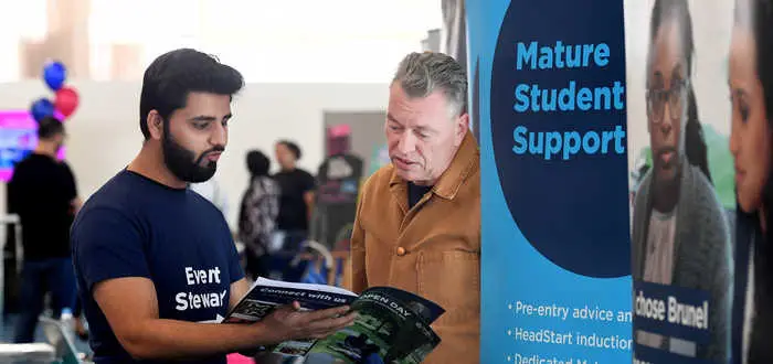 Mature student talking to staff at open day